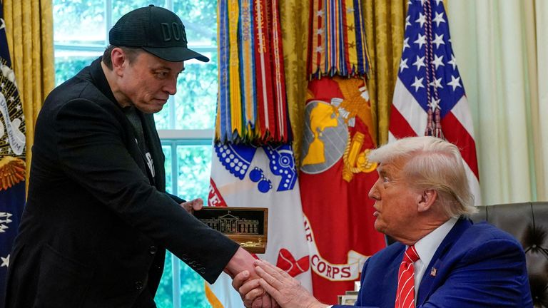Elon Musk receives a golden key from U.S. President Donald Trump in the Oval Office.
Pic: Reuters
