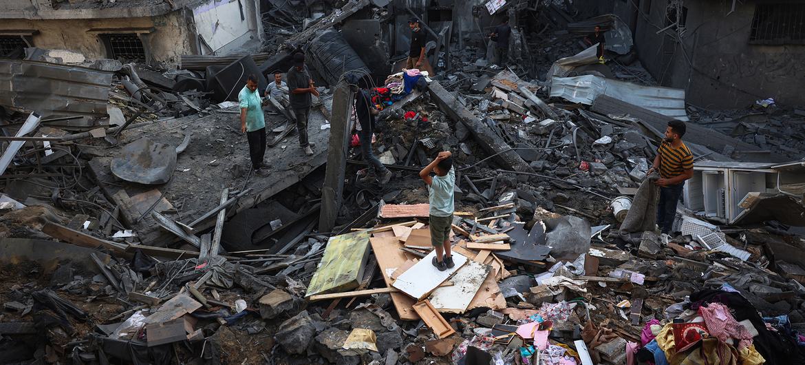 People search through the rubble of a destroyed building in the central Gaza Strip. People search through the rubble of a destroyed building in the central Gaza Strip.